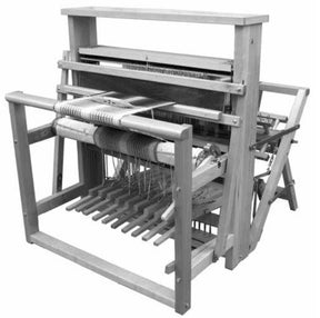 A black and white image of the Leclerc Nilus 8-Shaft 10-Treadle (Back Hinged) Jack Floor Loom by Leclerc Looms. The wooden handloom has multiple frames and beams, with threads intricately woven through slots. The setup includes pedals at the bottom and various levers for manual operation, showcasing traditional textile machinery.