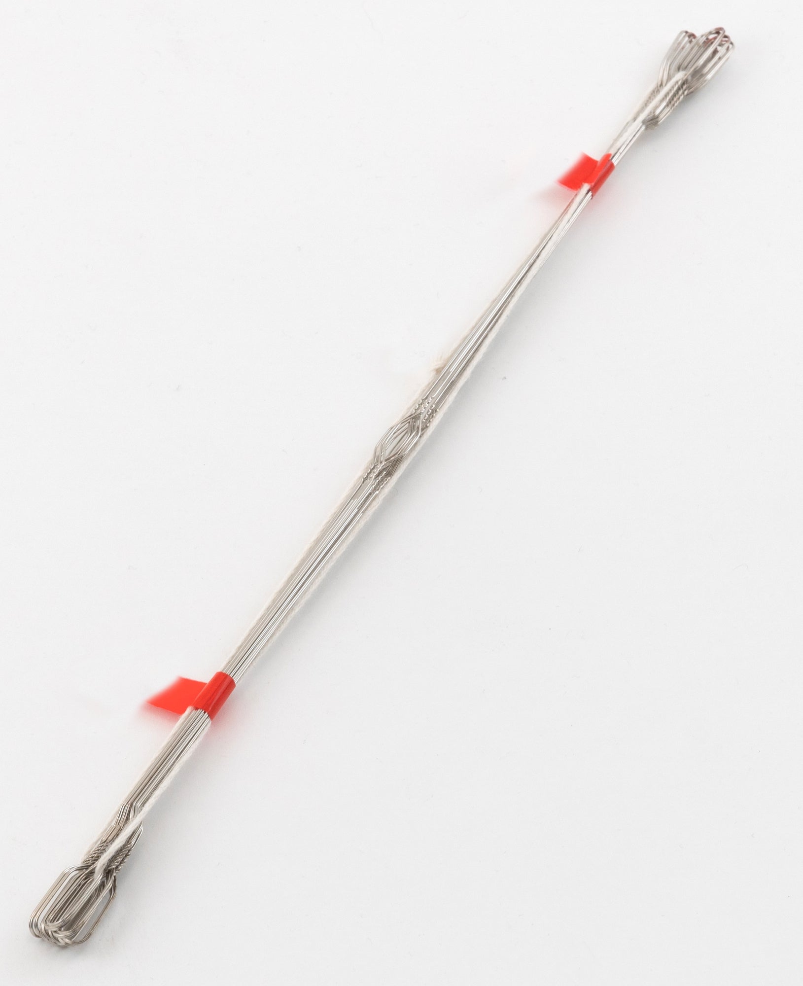 The Wire Repair Heddle from Leclerc Looms, featured as part of a 12-pack, consists of a silver metal wire resembling flat steel heddles. It is bent into a long, narrow loop with several twists and folds, securely fastened at two points with red plastic ties. The wire appears to be designed for industrial or crafting purposes and is photographed against a plain white background.