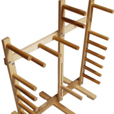 The Leclerc Cendrel Standing Inkle Loom/Warping Frame by Leclerc Looms features multiple horizontal pegs on two vertical supports, specifically designed to hold and display various items such as swords. The structure is sturdy with a natural wood finish, bearing an elegant simplicity much like that of a wooden sword rack.