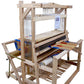 Displayed in this image is the Leclerc Colonial V2 Overhead Beater for 45" and 60" looms, manufactured by Leclerc Looms. This wooden handloom features various components including heddles, beams, and pedals. A colorful woven fabric is partially completed on the loom.