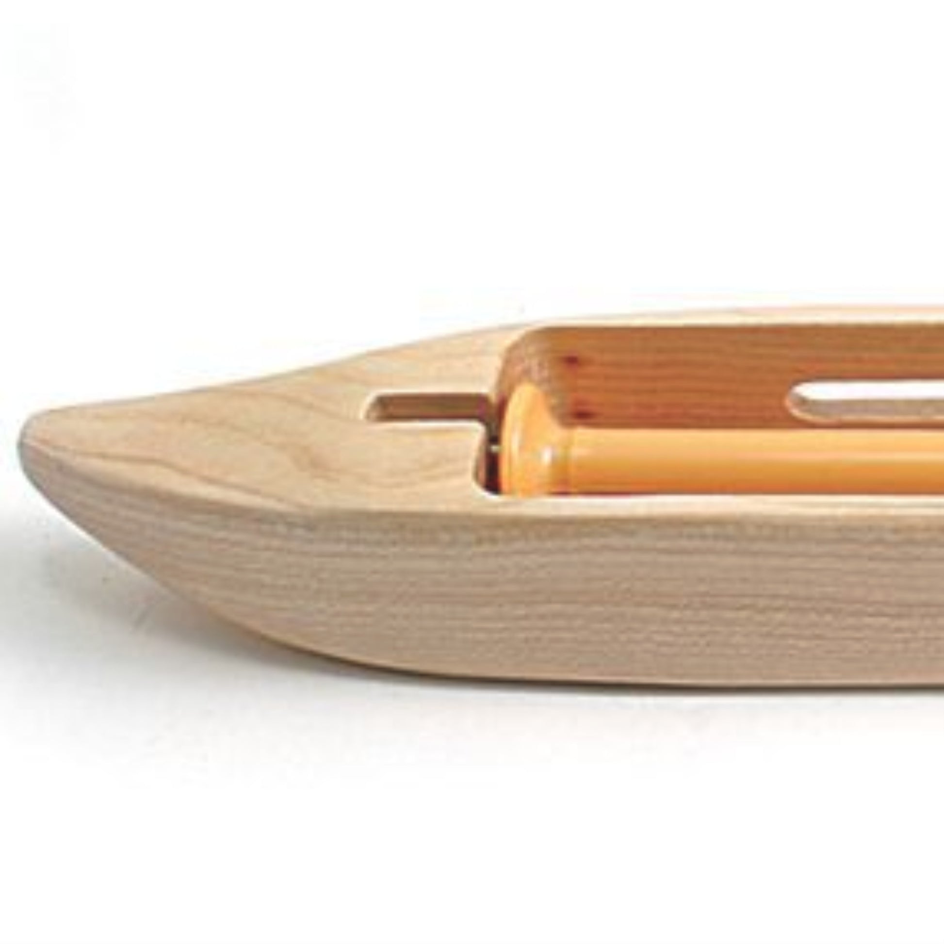 A detailed image of the Leclerc Double-Bobbin Boat Shuttle from Leclerc Looms, a boat-shaped tool commonly utilized in handweaving to efficiently carry the weft yarn back and forth between the warp threads. This shuttle features a smooth finish, an even tension system, and a cylindrical bobbin holder.