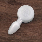 A close-up image of a small, round, translucent plastic peg with a conical tip lying on a wooden surface. The peg, commonly used in the Texsolv system for harness/shaft tie-up, is identified as a **Glimakra** **Texsolv Straight Arrow Peg**, with the word "FLEX SOLV" embossed on the round end.