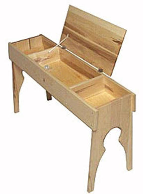 A Leclerc Loom Bench by Leclerc Looms is depicted with an open lid. The bench, designed for use with looms, boasts a rectangular box structure featuring a divided interior and stands on four intricately carved legs.