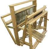 The Leclerc Artisat 36" Floor Loom by Leclerc Looms features a complex arrangement of beams, pedals, and levers. This robust structure includes metal heddles and a mechanism for holding threads in place, making it ideal for weaving textile materials.