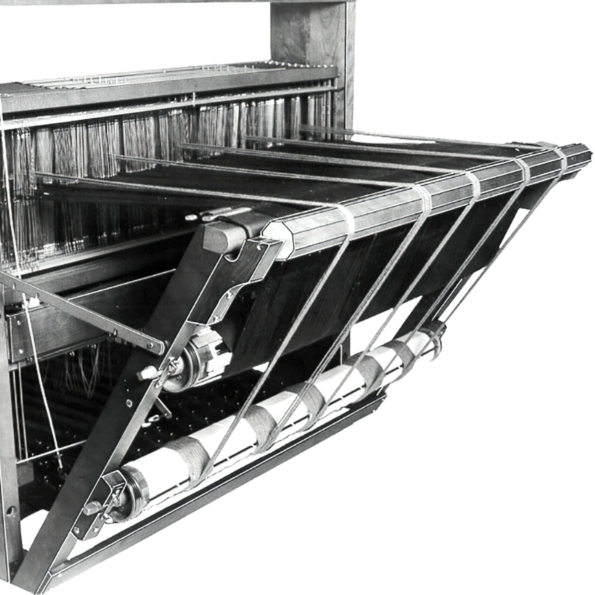 Black and white image of the Leclerc Double Warp Beam Standard from Leclerc Looms, a mechanical textile loom used for weaving. The machine features numerous strings, pulleys, and frames. It appears complex, with various mechanical parts and structures designed to facilitate the weaving process.