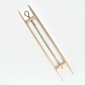 The Leclerc Rag/ Multi-purpose Shuttle with Rod by Leclerc Looms is a wooden shuttle with a metal rod and hook in the middle, set against a plain white background. This elongated, symmetrical tool with pointed ends is specifically designed for passing the weft thread through the warp threads in weaving, making it ideal for creating intricate rag rugs.