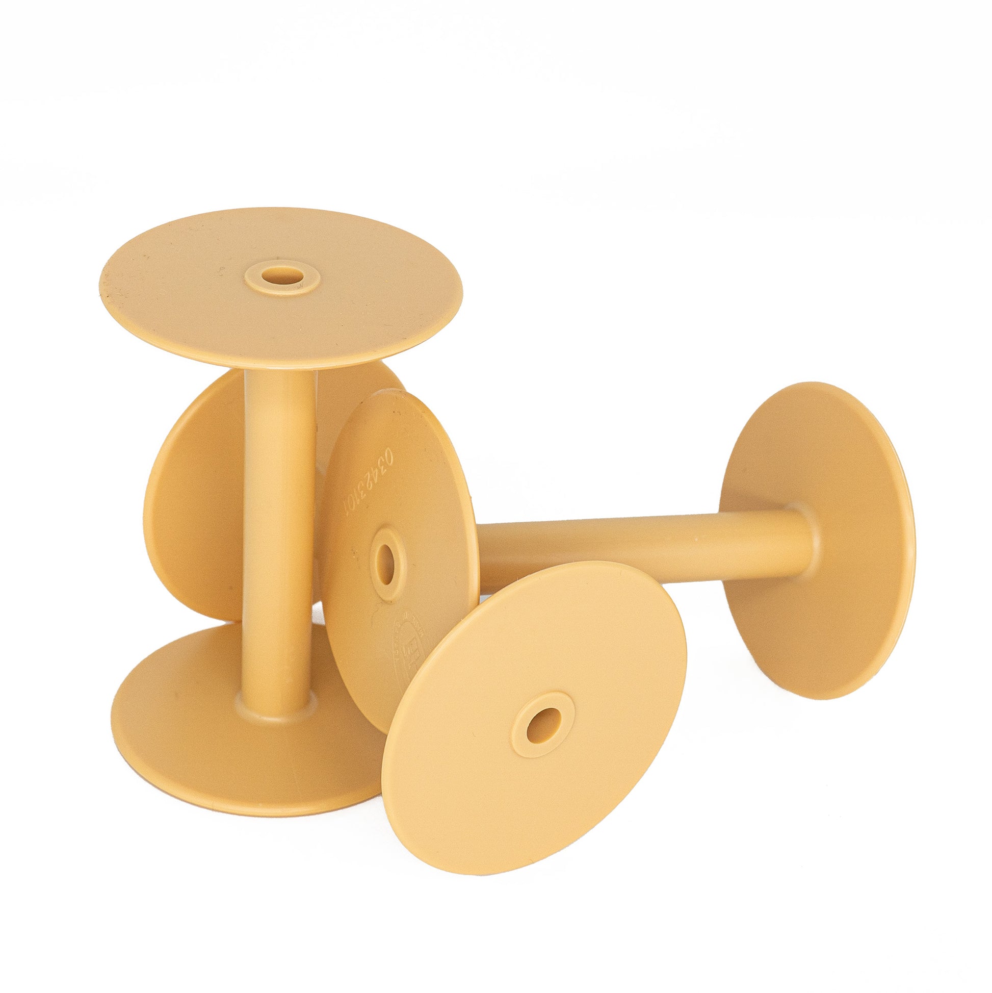 Four Leclerc 4" Styrene Spools, made by Leclerc Looms, with flat brown tops and cylindrical stems are neatly stacked together. These plastic spools have holes in the center of their circular bases and appear ideal for holding fine weight yarn.