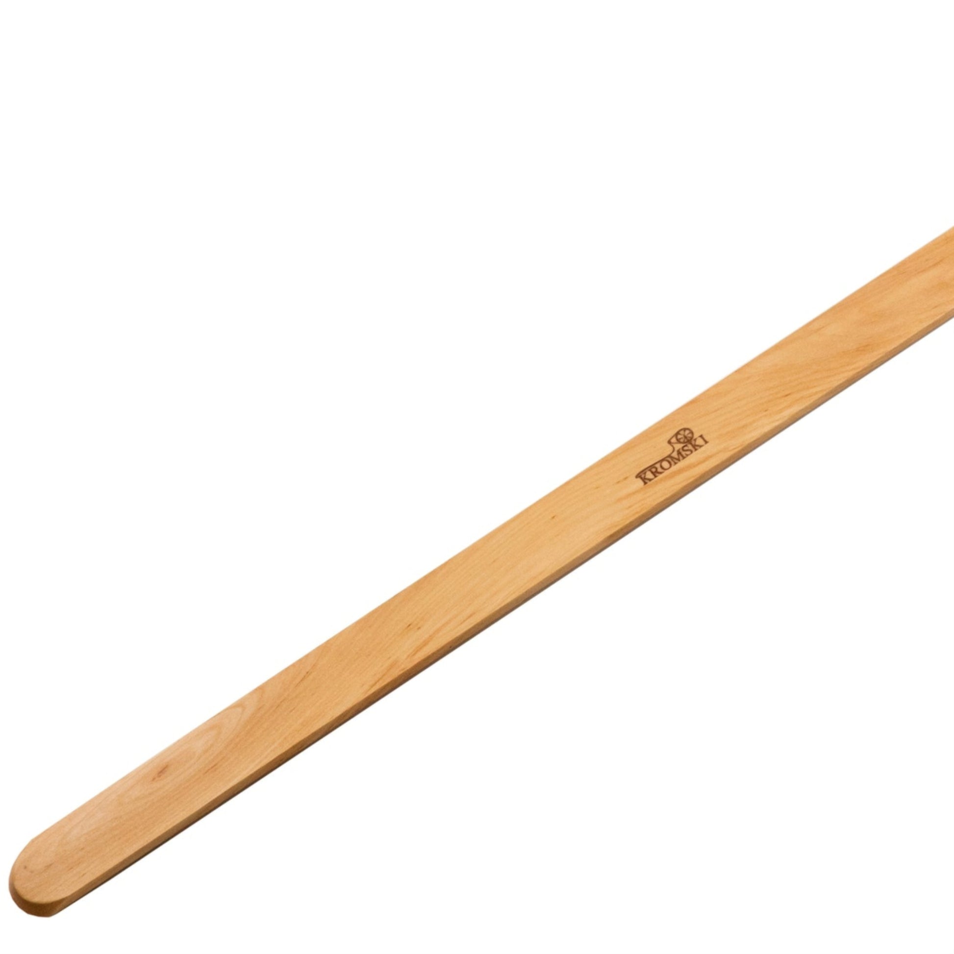 A single Kromski Pickup Stick Clear, made of smooth, light brown wood with a flat surface and rounded ends, laying horizontally. The tongue depressor-like tool from Kromski North America features a small logo printed near one end on a solid white background.