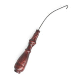 The Kromski Orifice Hook by Kromski North America is a wooden-handled tool featuring a curved metal hook, commonly used for crafts and leather work. Its handle displays a polished, intricate design with multiple finishes, while the angled metal hook extends elegantly from the top against a white background.