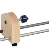 A wooden tool with a metal rod and a black rubber end cap, resembling the Schacht Double Ended Electric Bobbin Winder Live Center Replacement Kit by Schacht Spindle Co., equipped with an adjustable screw mechanism for tightening or loosening.