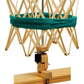 A Schacht Ultra Umbrella Swift by Schacht Spindle Co. holds a teal skein of yarn. The adjustable swift is clamped to the edge of a wooden table and features an expandable frame to accommodate different sizes of skeins up to 93 inches.