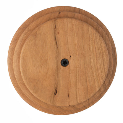 This is the Schacht Whorl, crafted by Schacht Spindle Co., featuring a round wooden design with a smooth surface and a central dark hexagonal screw. The natural grain patterns in the wood showcase varying colors from light to slightly darker shades.