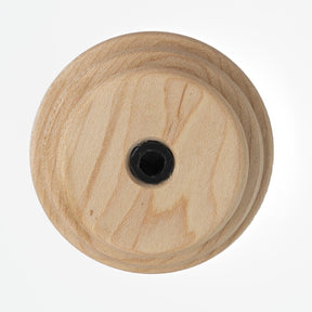 A round Schacht Whorl by Schacht Spindle Co., featuring a visible wood grain pattern and a central black screw hole, viewed from above.