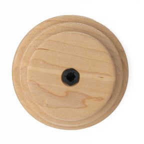 The Schacht Whorl by Schacht Spindle Co. is a circular wooden door pull with a central black mounting hole and smooth, concentric circular grooves in a light natural wood finish.