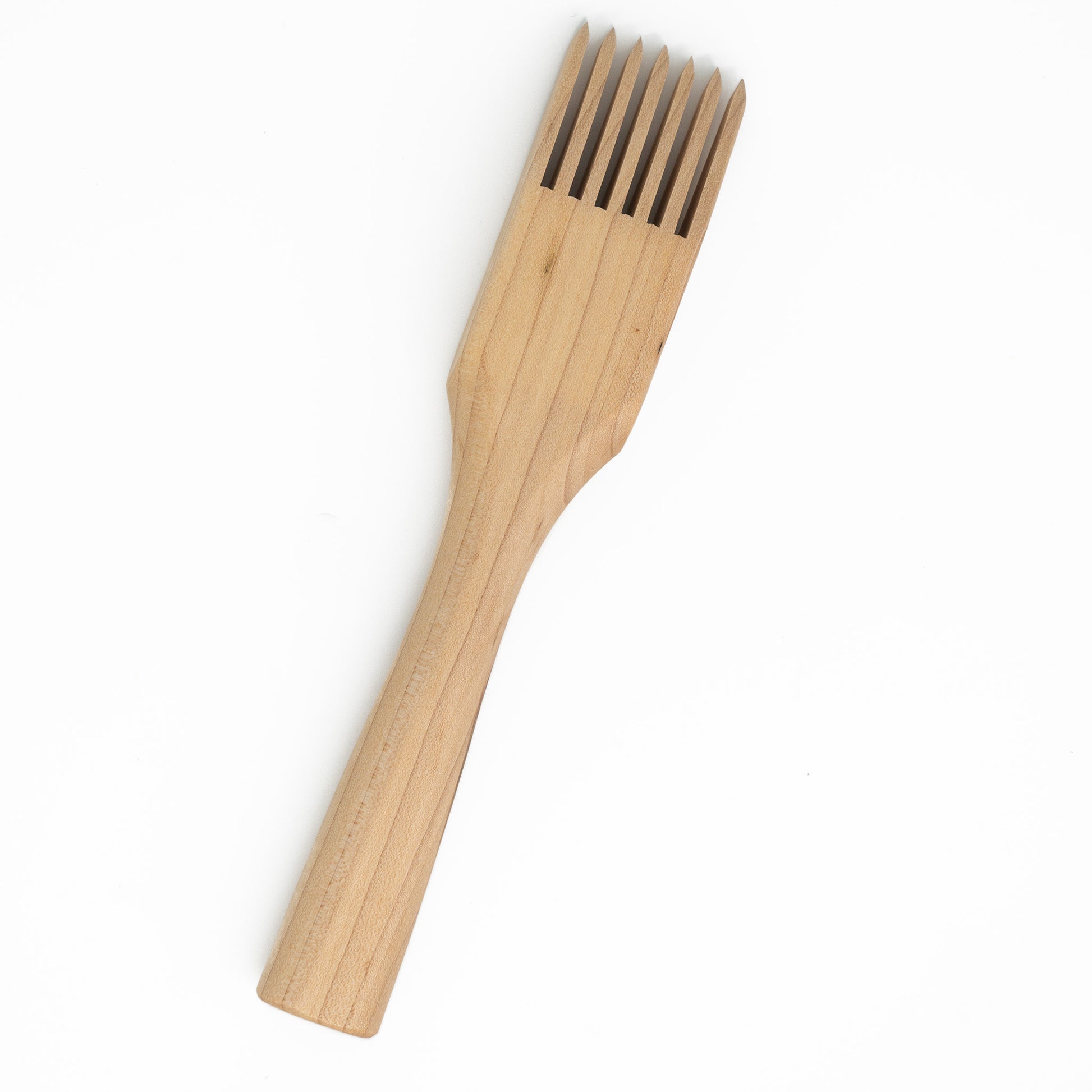 The Schacht Tapestry Beater by Schacht Spindle Co. features five wooden tines and a comfortable handle, with the wood boasting a smooth, natural finish. This exquisite tool is elegantly displayed against a plain white background.