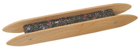 The Schacht Rag Shuttle by Schacht Spindle Co. is a wooden carpet stretcher tool with a sleek, elongated design and rounded ends. It features a rectangular, padded, dark-colored base adorned with small scattered red and white dots and metal screws on each side, making it perfect for rug weaving.