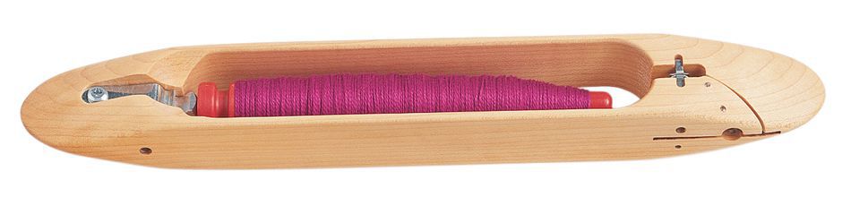 A Schacht End Delivery Shuttle from Schacht Spindle Co. is loaded with a bobbin of pink thread. The shuttle, similar to those used for Schacht Pirns, features an elongated design with a carved-out section to hold the bobbin and a metal piece at one end to guide the thread, ensuring even tension.