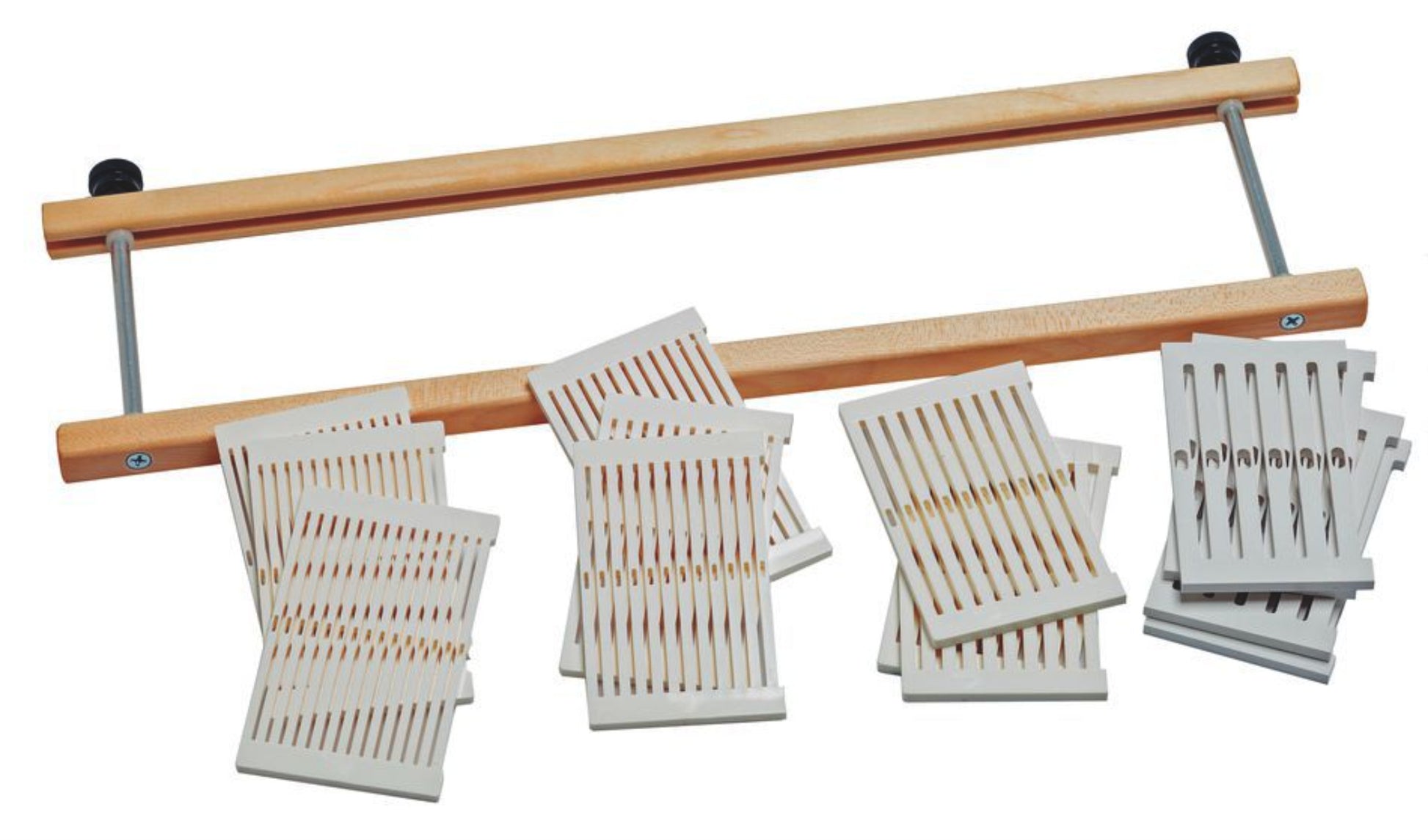 The image shows a wooden loom, possibly the renowned Schacht Rigid Heddle Loom Variable Dent Reed w/Segments from Schacht Spindle Co., with several weaving cards featuring a series of vertical and horizontal lines laid out on a white surface. The loom consists of a wooden frame with metal rods and is equipped with variable dent reeds.