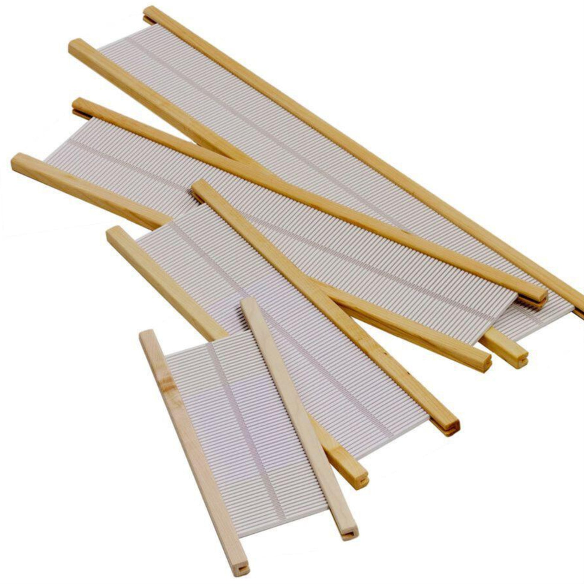 A collection of bamboo sushi rolling mats are scattered on a white background, reminiscent of the precision found in Schacht Rigid Heddle Reeds for Flip or Cricket Looms by Schacht Spindle Co. The mats vary in size, each featuring thin bamboo slats held together by woven string. Some mats are partially overlapping each other, much like weaving with two heddles.