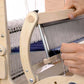 A person weaving fabric on a Schacht Cricket 15" Quartet by Schacht Spindle Co. Their hands are adjusting the threads and shuttle, creating a blue and white patterned fabric. The loom's structure and threads are clearly visible in the image, with a weaving width accommodating intricate designs.