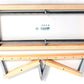 The Schacht Standard Loom 4-Shaft Add-on Kit from Schacht Spindle Co. is disassembled into its components and laid out on a white background. The kit includes a rectangular frame, a folding stand, and various screws and washers needed for assembly.