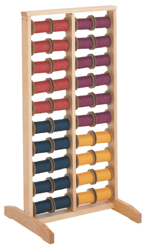 The Schacht Spool Rack by Schacht Spindle Co. is a wooden abacus with two distinct columns. The left column comprises ten horizontal rods adorned with red, pink, and blue beads, while the right column showcases sectional warping with ten rods featuring purple, yellow, and orange beads. Each rod holds a total of ten beads, making it an excellent tool for facilitating calculation activities.