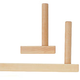 The Schacht Warping Pegs from Schacht Spindle Co. feature a thick horizontal bar attached to a vertical handle, with an additional cylindrical handle above it, resembling warping pegs against a white background.