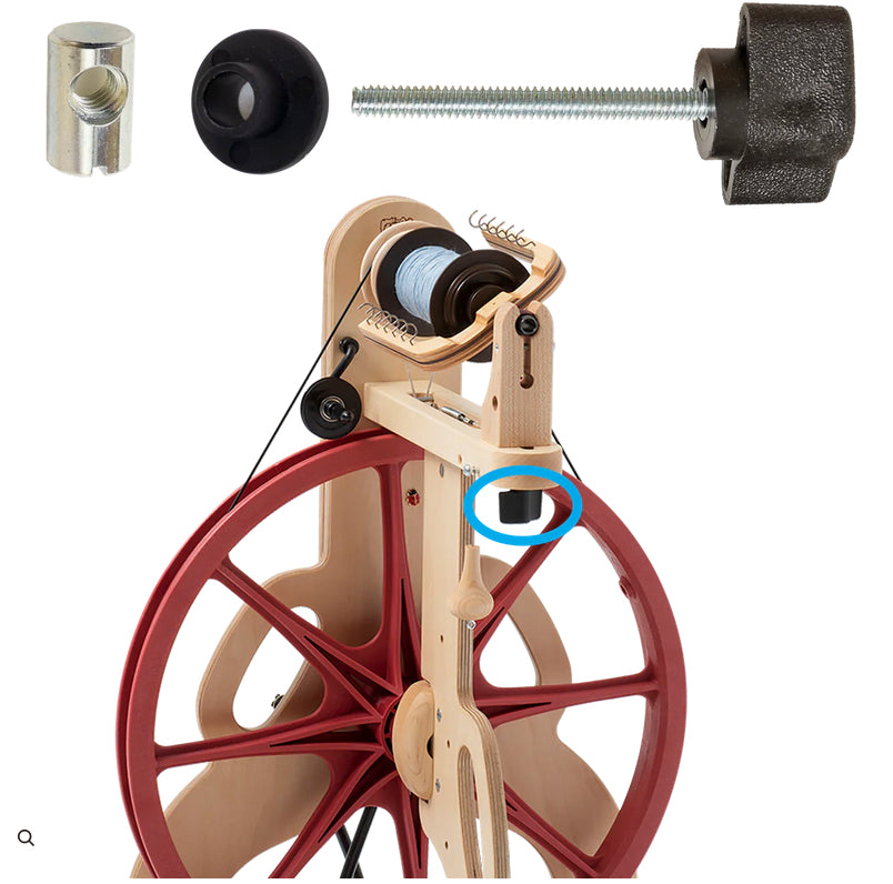 A Ladybug Front Maiden Knob Kit, produced by Schacht Spindle Co., features a wooden spinning wheel with red spokes displayed on a white background. Various components, such as a tire, maiden knob, and threaded metal pieces, are arranged above the wheel. The wheel showcases a blue circle highlighting a specific part of the machine.