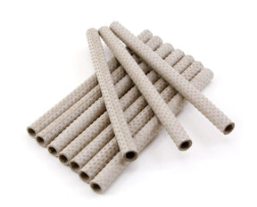 A collection of Glimakra Paper Quills (10/pack), reusable and textured like weaving bobbins, lies haphazardly on a white background. These light-colored quills feature a dotted pattern and have hollow centers.