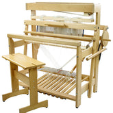 The Louët David 3, 8-Shaft Floor Loom by Louët Inc. is a wooden weaving loom that comes with several spools of thread and various components essential for weaving. It includes a bench for the user to sit on while operating the loom. The loom is set up and ready for weaving with threads arranged and prepared.