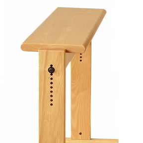 The Louët Loom Bench by Louët Inc. is a light wooden kneeling bench with an adjustable height, featuring a simple, minimalist design with smooth edges and visible wood grain. The bench has a top plank supported by sidepieces that include multiple height adjustment holes and a locking pin for secure customization.