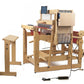 A modern, wooden Louët Megado Floor Loom without Dobby Control Head sitting next to a matching wooden bench from Louët Inc. The loom features an intricate structure with various levers and parts, complemented by a built-in digital interface with a screen and control panel. Power cords are visible on the floor.