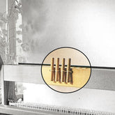 An image depicts a Louët table loom in operation, with a close-up inset circle highlighting four wooden pegs or rods on a brass bar. The surrounding area includes parts of the loom and blurred background elements. Nearby, a replacement Louët Table Loom Toggle Handle by Louët Inc. is visible.