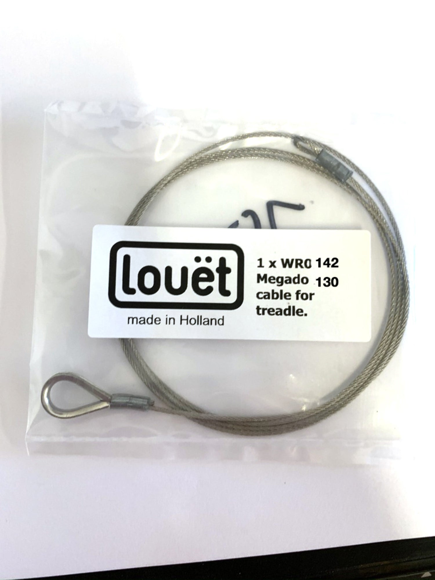 A Louët Inc. branded package contains a coiled replacement cable for the Louët Megado 130 treadle. The label reads "Louët made in Holland, 1 x WRQ 142 Megado 130 cable for treadle," and the cable features metal loops at both ends. Ideal for Louet Megado looms, it comes in clear plastic packaging as the Louët Megado Treadle Cable.