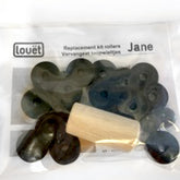 A plastic bag labeled "Louët Jane roller conversion kit" from Louët Inc. contains various small dark-colored parts and a cylindrical wooden piece. The background is white, and the label mentions the name "Jane," referencing Jane loom rollers.