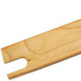 A detailed close-up image of the Harrisville Backstrap Shuttle Beater from Harrisville Designs shows its light-colored wooden stick design with a notched end and a hole near the edge. The visible wood grain highlights its natural, unfinished appearance. Ideal for weaving loom accessories, it is set against a plain white background.