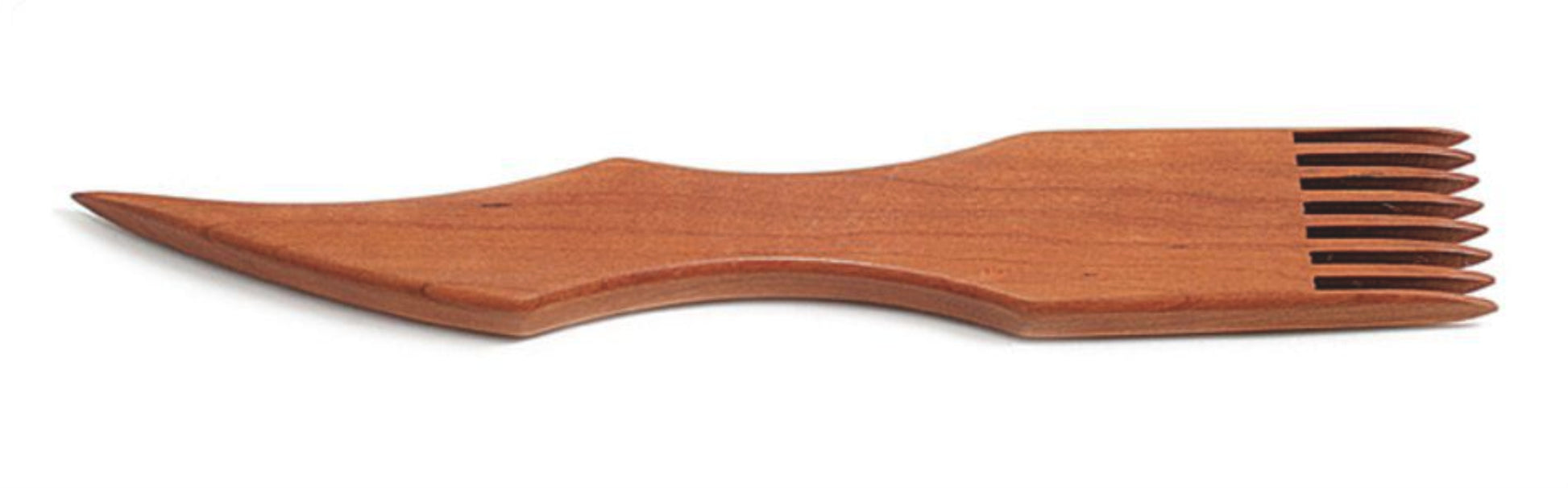 Introducing the Dovetail Cherry Tapestry Beater, beautifully crafted with a unique design. This elegant utensil features a smooth handle and a wide end that combines five fork tines with a spoon-like shape. Made from exquisite cherry wood, it boasts a polished finish reminiscent of traditional Navajo tools.