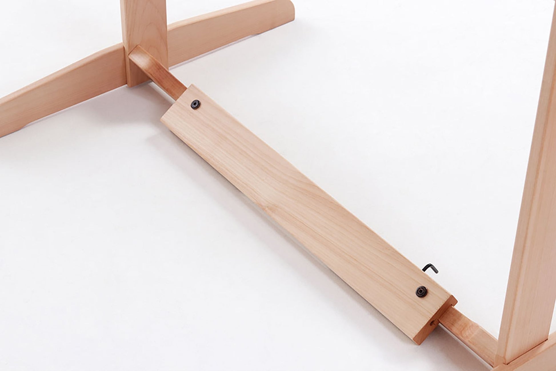 A close-up of the Ashford Rigid Heddle Table Stand by Ashford Handicrafts Limited, showcasing a wooden leg assembly. It features two legs joined by a horizontal support beam secured with screws, all set against a white background.