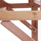 A close-up view of the Ashford Rigid Heddle Table Stand by Ashford Handicrafts Limited reveals a wooden furniture joint with intricate metal hinges. The wood boasts a smooth finish, complemented by an engraved design of a spinning wheel and the word "Stokke" on one of the surfaces. This stand offers an adjustable weaving angle, all set against a plain, soft white background.