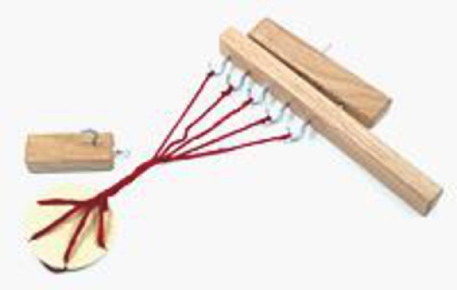 The Leonardo Rope Maker & Yarn Twister by Lacis is displayed. It features a handmade wooden loom with a rectangular base equipped with nails, several red threads that extend from it and are hooked to a circular wooden disk. A small rectangular wooden piece is attached to the disk, functioning as a rope maker.