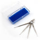 Displayed on a clean white surface, the Handy Hands Mini Hook Ring Set features four versatile lock picks in sizes 6, 10, 12, and 15. They come neatly attached to a single key ring and are encased in a transparent plastic case with a blue foam insert.