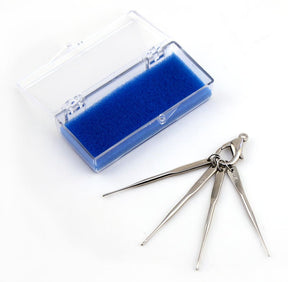 Displayed on a clean white surface, the Handy Hands Mini Hook Ring Set features four versatile lock picks in sizes 6, 10, 12, and 15. They come neatly attached to a single key ring and are encased in a transparent plastic case with a blue foam insert.