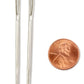 Two Large-Eyed Tapestry Needles from Accessories Unlimited are placed vertically next to a U.S. penny, which features the profile of Abraham Lincoln. The metallic needles, slightly larger than the penny, stand out against the white background, highlighting their shiny appearance and size ideal for bulky weight yarns.