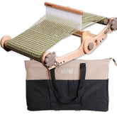 A portable Ashford Rigid Heddle Knitters Loom with light-colored wood and partially woven green yarn is shown alongside a beige and black carrying case featuring the text "Ashford Wheels & Looms." The loom, from Ashford Handicrafts Limited, includes metal gears and a wooden heddle.