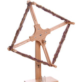 The Ashford Skeiner 2 by Ashford Handicrafts Limited stands upright on a sturdy wooden base. This wooden yarn swift features a cross-shaped frame with adjustable arms and is wrapped with multicolored spun yarn. Ideal for holding skeins of yarn, it is perfect for winding them into balls.