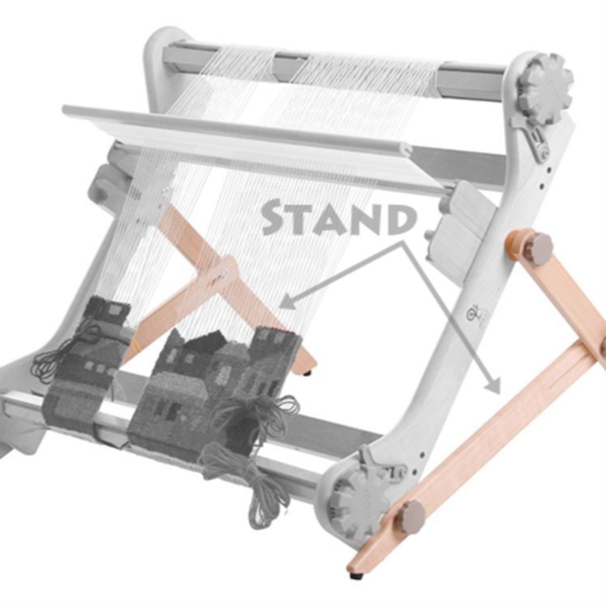 A tabletop Rigid Heddle Loom featuring the Ashford Rigid Heddle Table Stand for support. The loom boasts a gray and white frame with horizontally threaded strings, and completed pieces of fabric adorned with house patterns hanging at the bottom. The stand is labeled "STAND" with arrows pointing towards it from Ashford Handicrafts Limited.