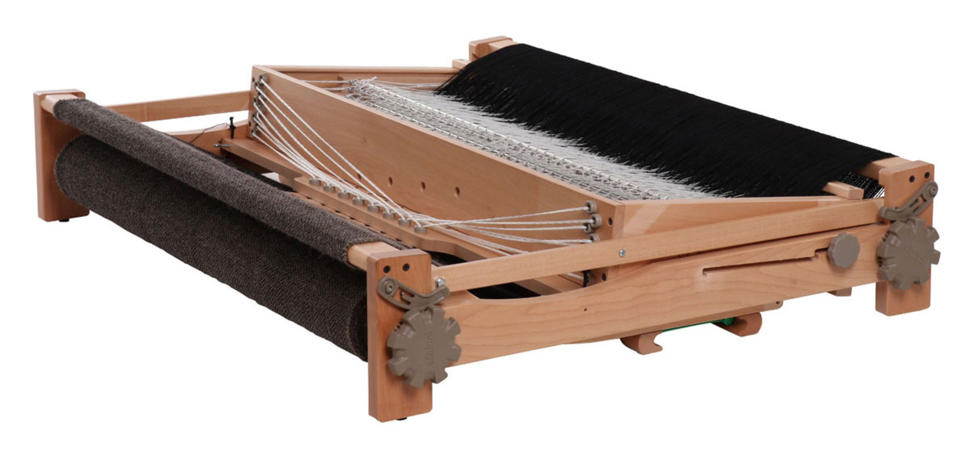 The Ashford Table Loom, with Overhead/Swinging Beater by Ashford Handicrafts Limited, is perfect for weaving enthusiasts. This compact loom features a flat, rectangular base and various components that guide the yarn into fabric. Discover the precision of Texsolv heddles with this exceptional wooden table loom equipped with metal gears and black and white threads.