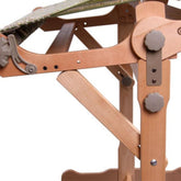 A close-up of the Ashford Support Brace Kit for Knitters Loom Stand by Ashford Handicrafts Limited, showcasing adjustable knobs, mechanical parts, and a sturdy support brace kit that illustrates the detailed craftsmanship and design for securely positioning canvases or artwork.