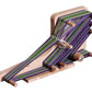 The Ashford Inklette Loom by Ashford Handicrafts Limited is a lightweight wooden loom, threaded with tightly woven green, purple, and black threads. It features multiple pegs to hold the weaving length in place and is set on a flat wooden base with intricate weaving in progress.