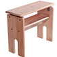 The Ashford Hobby Bench 2 by Ashford Handicrafts Limited is a wooden weaving bench featuring a rectangular seat and sturdy legs. The design incorporates a lower shelf for extra support and storage. Constructed from light-colored silver beech hardwood, it has a simple, functional design with visible screws at various connection points.